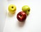 Top view of fruits. Three fresh and shiny green, red and yellow apples on a white background Â 